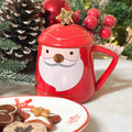 Tazza natalizia rossa con decoro Babbo Natale, barba bianca e naso dorato, con coperchio coordinato